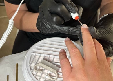 Nail technician provides manicure at The Snug Room, Ravenfield, England, GB, highlighting precision nail care.