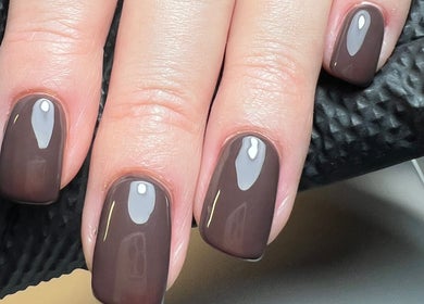 Stylish chocolate brown nails from The Snug Room in Ravenfield, England, GB, showcasing glossy finish.
