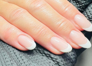 Elegant French manicure at The Snug Room, Ravenfield, England, GB showcasing neatly groomed nails.
