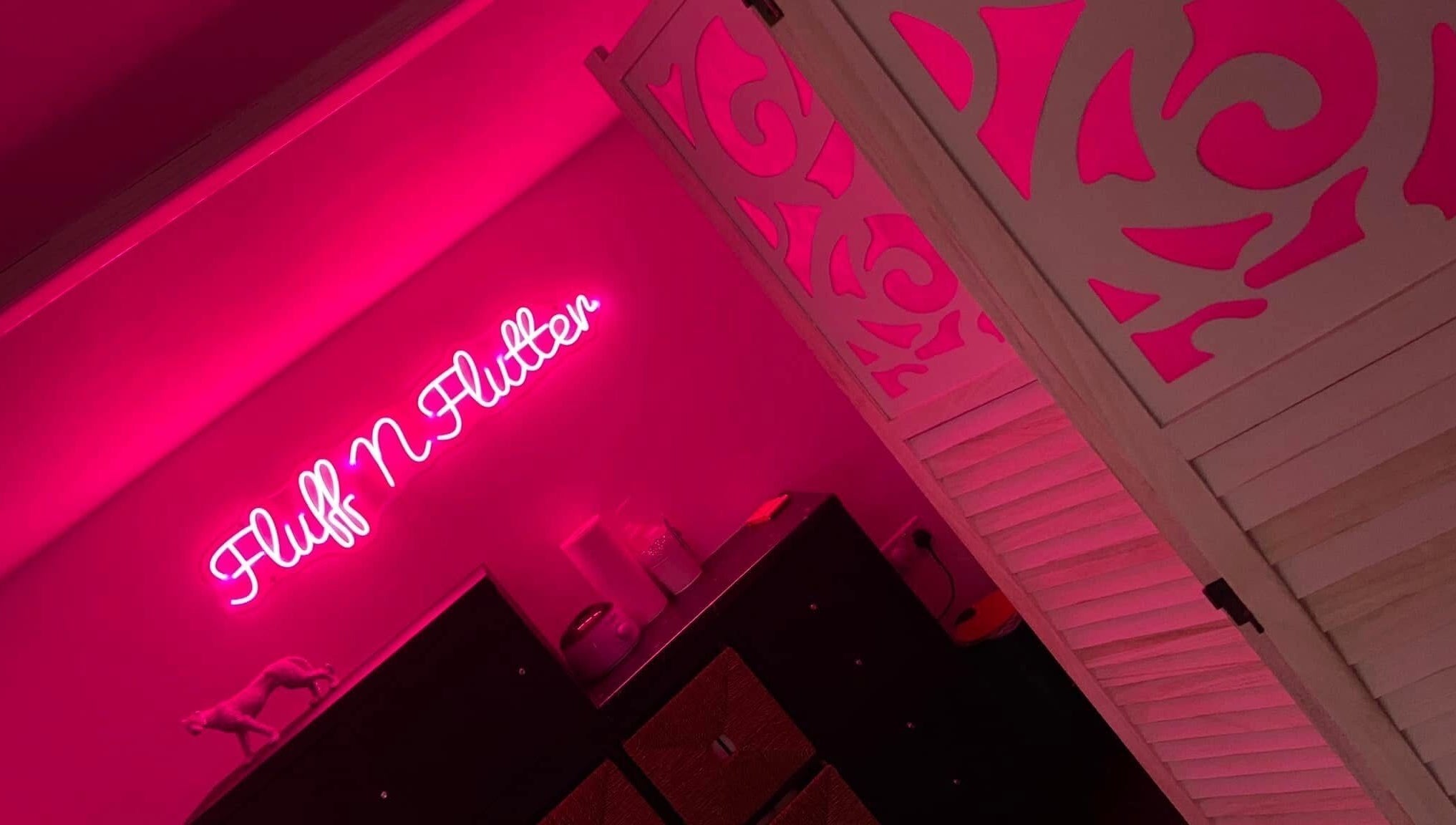 Warm pink neon sign in Fluff n Flutter, Mansfield, England, GB, creating a calming ambiance.