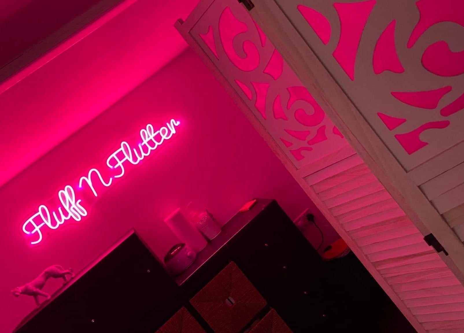 Warm pink neon sign in Fluff n Flutter, Mansfield, England, GB, creating a calming ambiance.