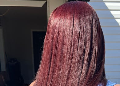 Rich burgundy hair at The Purple Door Styling & Grooming Lounge in Spartanburg, South Carolina, US.