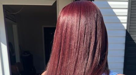 Rich burgundy hair at The Purple Door Styling & Grooming Lounge in Spartanburg, South Carolina, US.