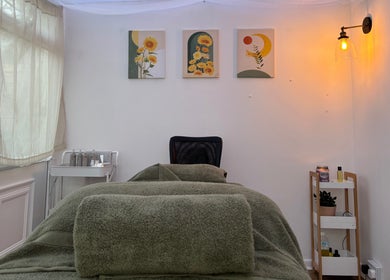 Cozy therapy room at Mia Wellness Room with green bed linens, Penryn, England, GB.
