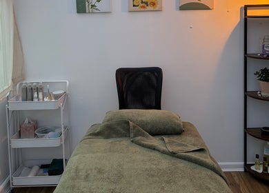 Cozy treatment room at Mia Wellness Room, Penryn, England, GB featuring a massage table and soothing decor.