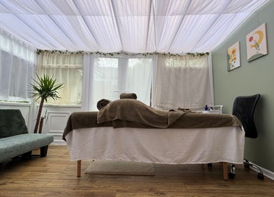 Relaxing massage room at Mia Wellness Room, Penryn, England, GB featuring a cozy table and calming decor.