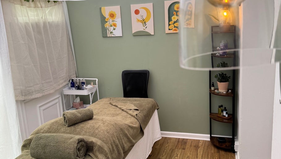 Relaxing treatment room at Mia Wellness Room, Penryn, England, GB with a massage bed and calming decor.