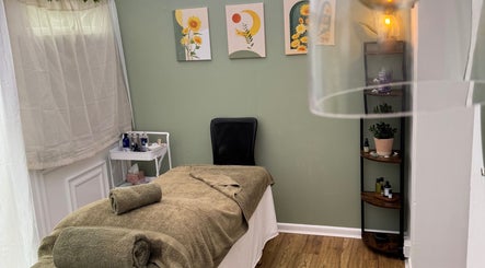 Cozy treatment room at Mia Wellness Room, Penryn, England, GB with massage bed and calming decor.