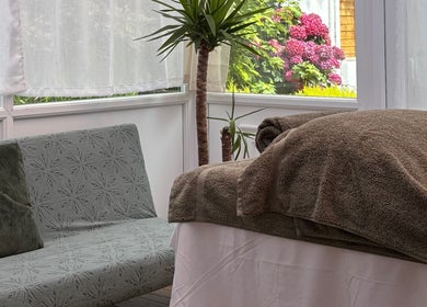 Relaxing treatment room at Mia Wellness Room, Penryn, England with soft lighting and plush decor.