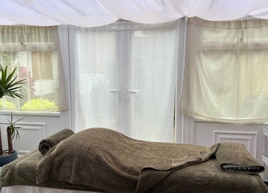 Relaxing treatment room at Mia Wellness Room, Penryn, England, GB, featuring comfortable massage bed and soft lighting.
