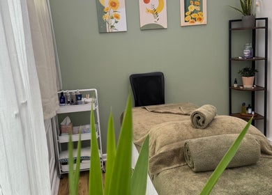 Spa treatment room at Mia Wellness Room, Penryn, England, GB with massage table and serene decor.