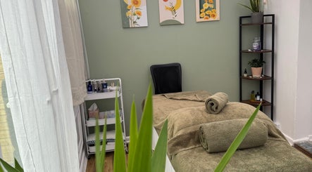 Spa treatment room at Mia Wellness Room, Penryn, England, GB with massage table and serene decor.