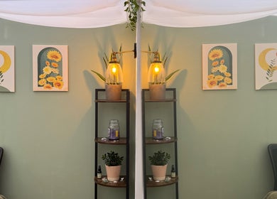 Bright decor in Mia Wellness Room, Penryn, England, GB, featuring wall art and warm lighting.