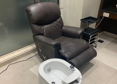 Cozy leather chair at Men Salon In Rozana Hotel, Muscat Governorate, OM, offering top-notch wellness experience.