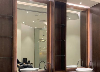 Chic interior of Men Salon in Rozana Hotel, Muscat, with modern mirrors and basins.