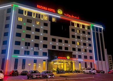 Exterior of Rozana Hotel illuminated at night. Men Salon In Rozana Hotel, Muscat, Muscat Governorate, OM.