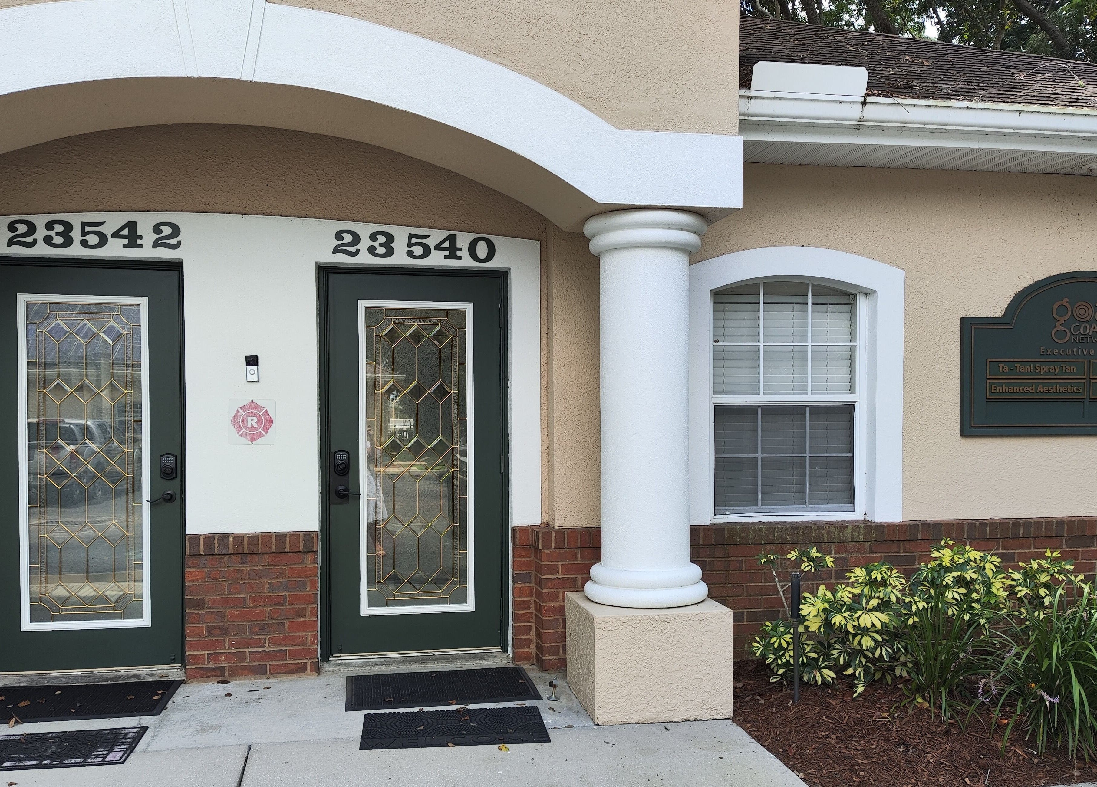 Entrance to Irina Titovets • Eyelash Extensions at 23540 Lutz, Florida, US, adorned with plants.