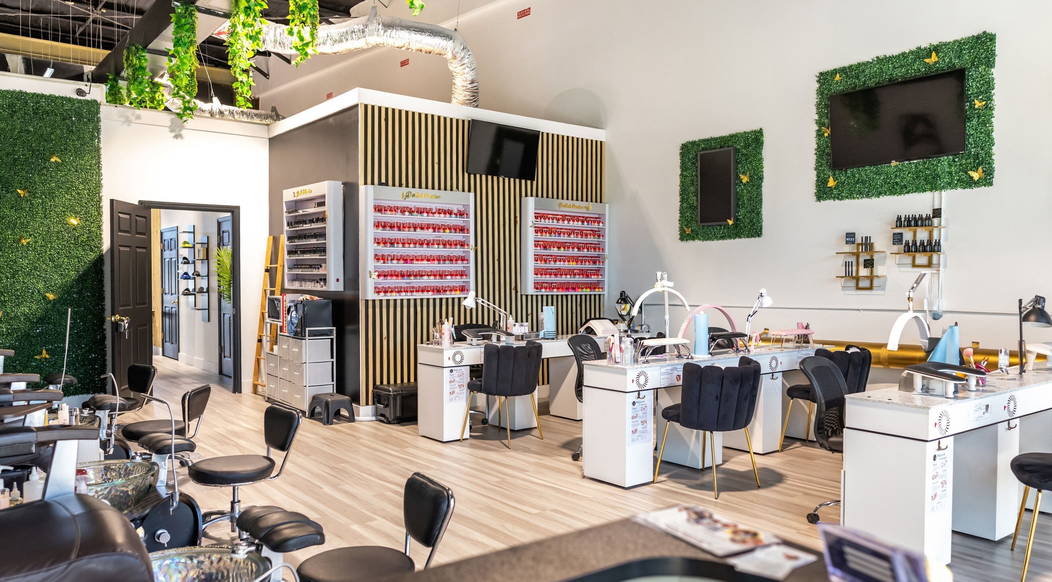 Interior of Precious Nails & Beauty in St. Cloud, Florida, US, showcasing modern nail stations and lush decor.