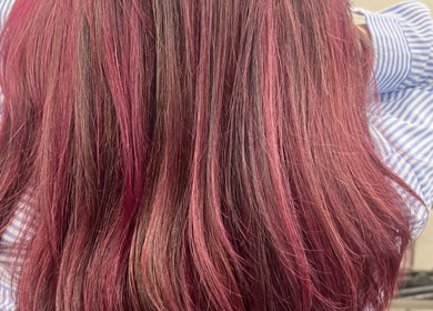 Vibrant pink-red hair expertly styled at D_A hair Design, London, England, GB.
