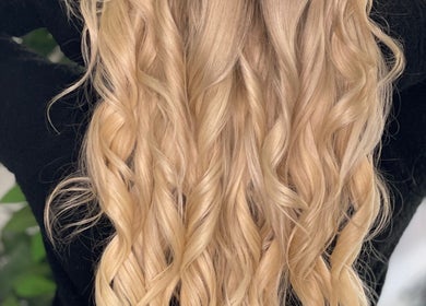 Beautiful blonde curls styled at D_A Hair Design, London, England, GB, showcasing expert hair artistry.