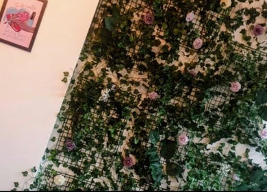 Lush floral display at The Hair And Beauty Corner, Manchester, England, GB, adding botanical charm.