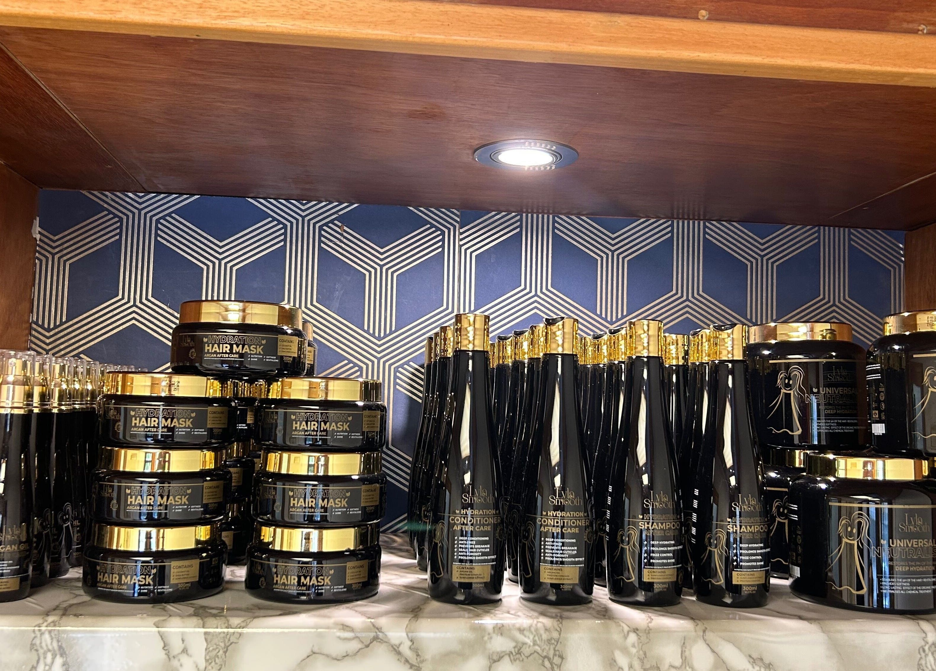 Premium hair care products on wooden shelf at Keratin by Anais, London, England, GB.