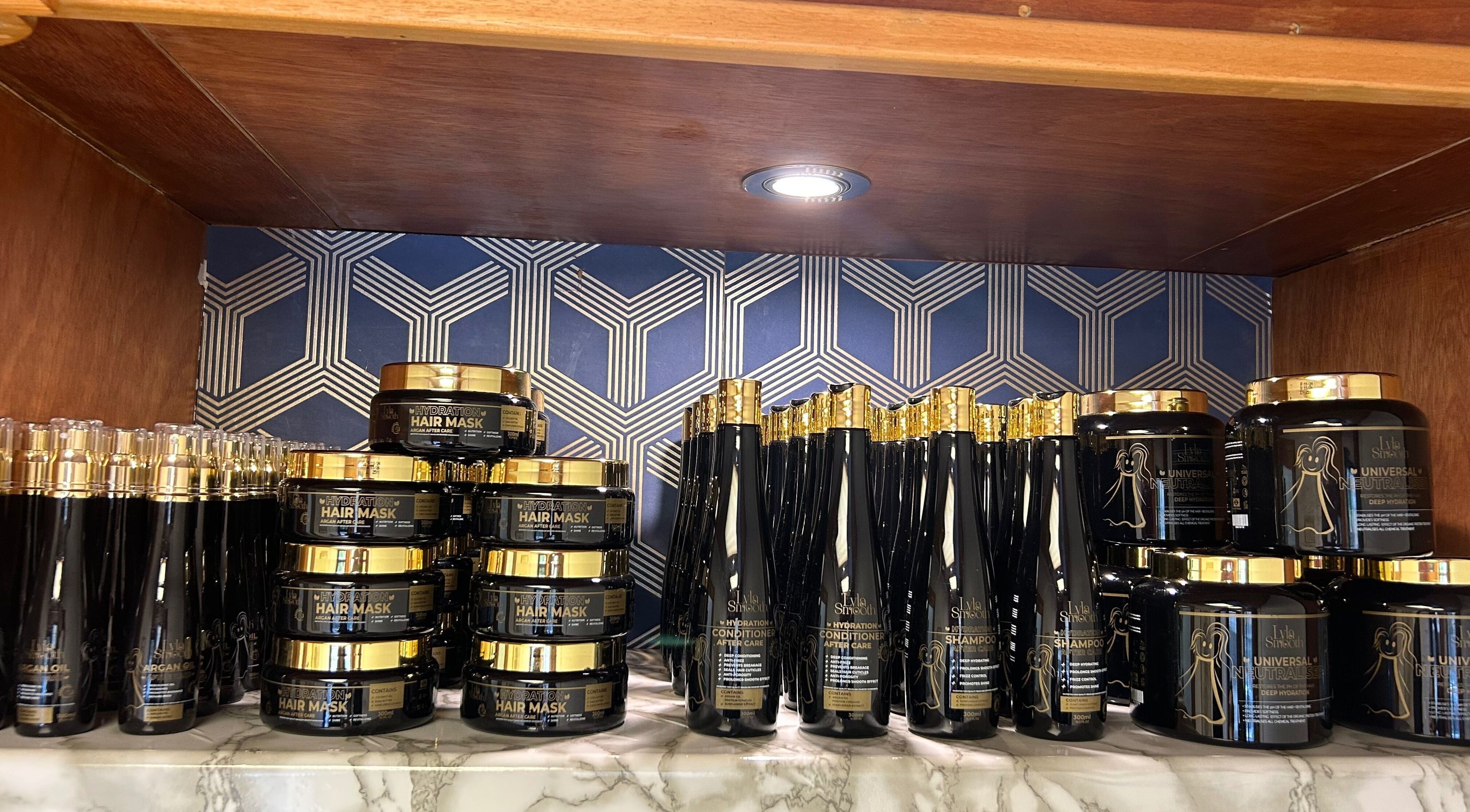 Premium hair care products on wooden shelf at Keratin by Anais, London, England, GB.