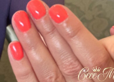 Vibrant coral nails manicure at Cece Mol Beauty, York, England, GB showcasing elegant hand care.