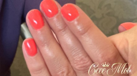 Vibrant coral nails manicure at Cece Mol Beauty, York, England, GB showcasing elegant hand care.