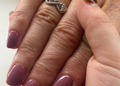 Close-up of manicured nails with a glossy finish at Cece Mol Beauty, York, England, GB.