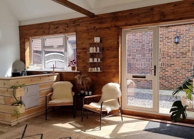 Warm wooden interior of B L The Hair Collective in Hastings, England, GB, showcasing a serene waiting area.