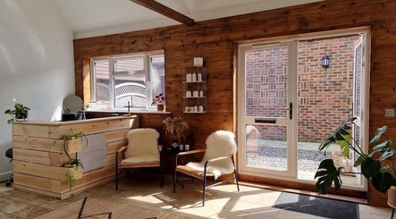 Warm wooden interior of B L The Hair Collective in Hastings, England, GB, showcasing a serene waiting area.