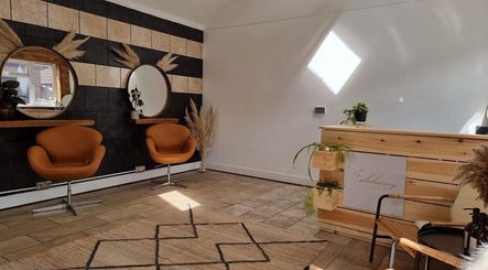 Stylish salon interior at B L The Hair Collective, Hastings, England, GB featuring modern decor and cozy seating.