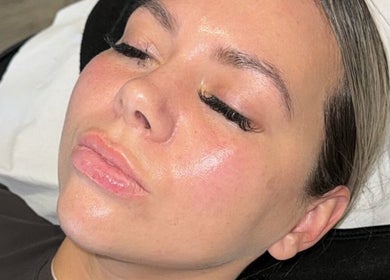 Client enjoying facial treatment at GLOW Skincare & Tanning, Saint Helens, England, GB with flawless results.