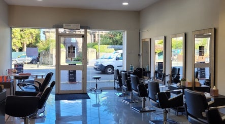 Bright interior of Mesmerising Beauty salon in Newcastle upon Tyne, England, GB, showcasing modern styling chairs.