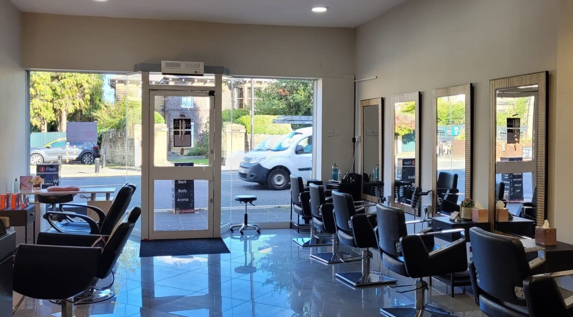Bright interior of Mesmerising Beauty salon in Newcastle upon Tyne, England, GB, showcasing modern styling chairs.