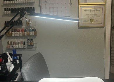 Nail polish display and workspace at Polished by Meg, Country Club, Florida, US, showcasing beauty professionalism.