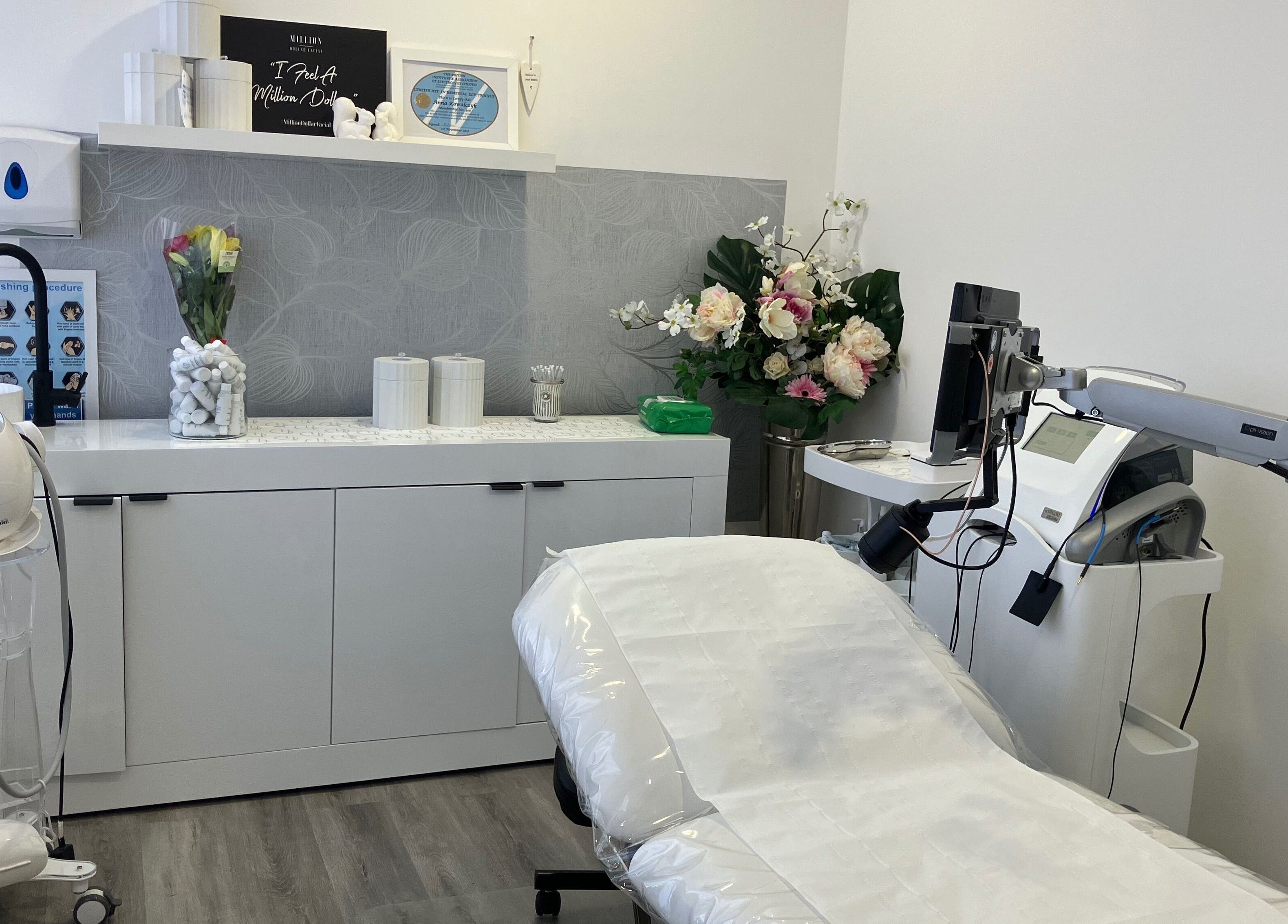 Relaxing beauty treatment room at Anja Gosha, Cardiff, Wales, GB with modern equipment and floral decor.