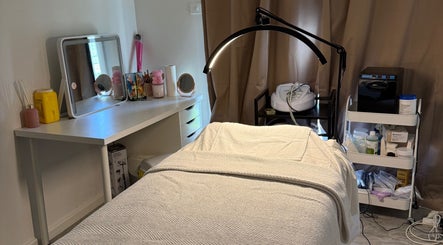 Therapy room at Your Skin Bar, Melbourne, Victoria, AU showcasing a cozy treatment bed and mirror.