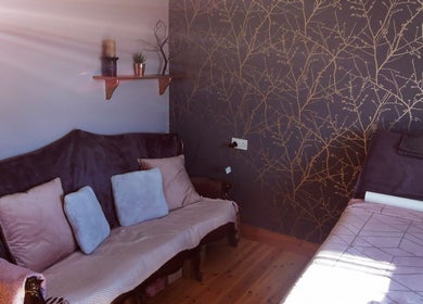 Inviting treatment room at Rural Aesthetics, County Monaghan, featuring plush seating and subtle decor.