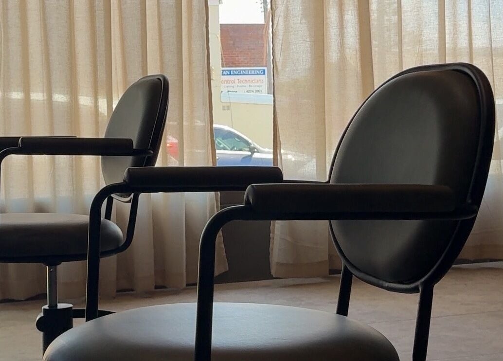 Modern salon chairs by window at Atelier Annelise, Port Kembla, New South Wales, AU.