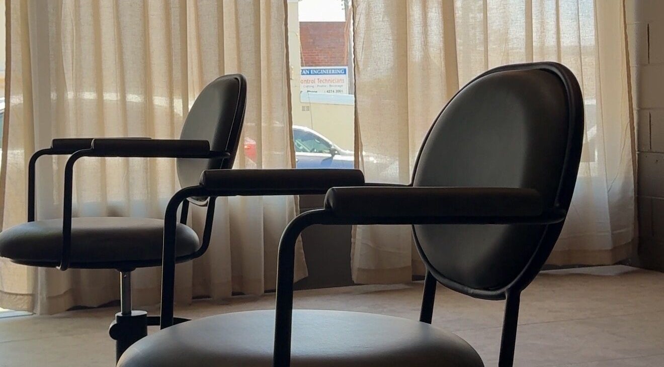 Modern salon chairs by window at Atelier Annelise, Port Kembla, New South Wales, AU.