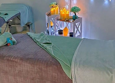 Cozy massage room at Tranquility Massage Therapy, La, England, GB with soft lighting and plush towels.