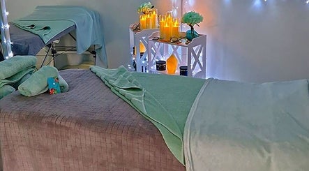 Cozy massage room at Tranquility Massage Therapy, La, England, GB with soft lighting and plush towels.