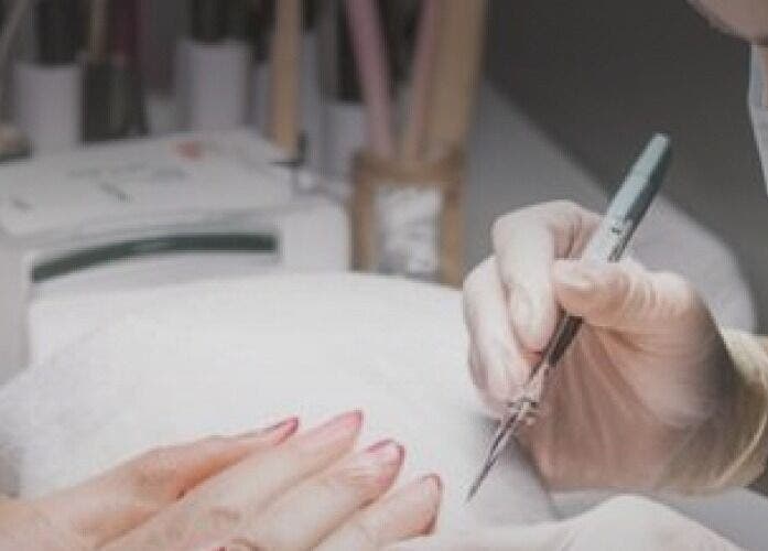Nail technician at Seven Cures in Riyadh providing precise manicure service. Experience luxury beauty care today.