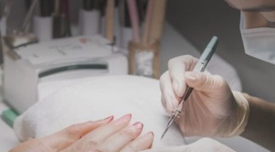 Nail technician at Seven Cures in Riyadh providing precise manicure service. Experience luxury beauty care today.