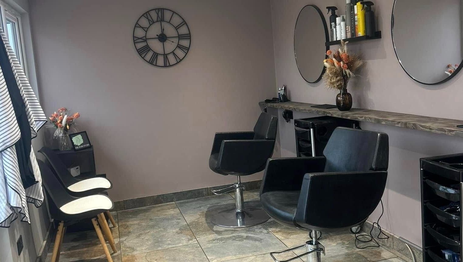 Modern salon setup at The Hair Studio in Ellesmere Port, England, GB featuring stylish chairs and decor.