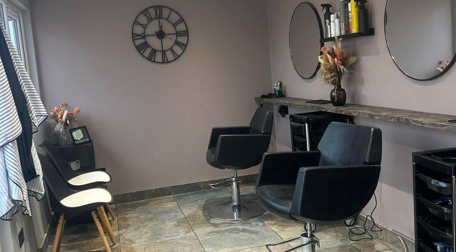 Modern salon setup at The Hair Studio in Ellesmere Port, England, GB featuring stylish chairs and decor.