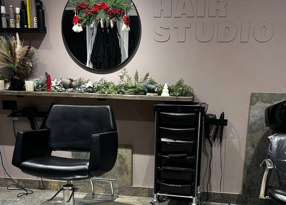 Modern salon chair and decor at The Hair Studio, Ellesmere Port, England, GB.