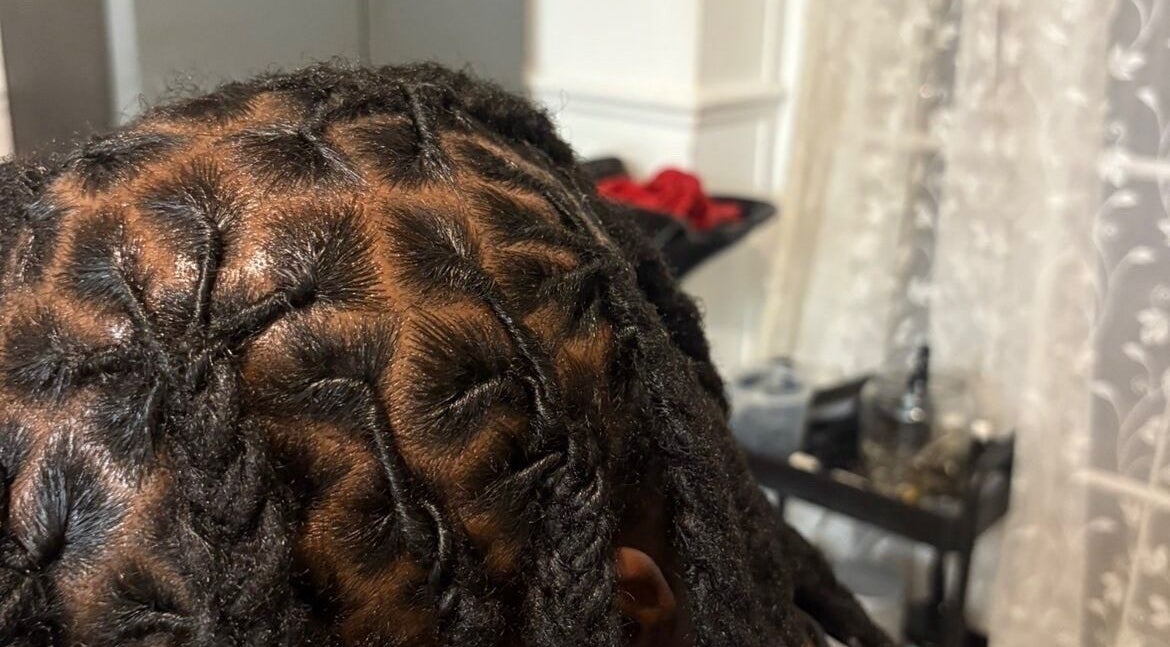 Intricate hairstyle showcasing tight braids at Kovalocs, London, England, GB.